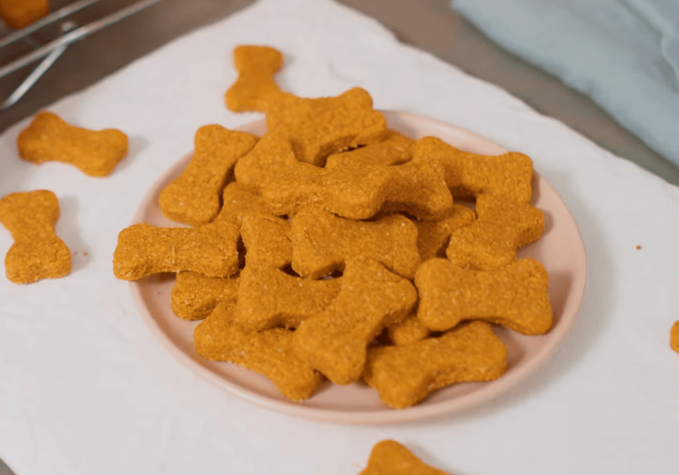 Freshly baked homemade dog treats shaped like bones, made with natural ingredients.