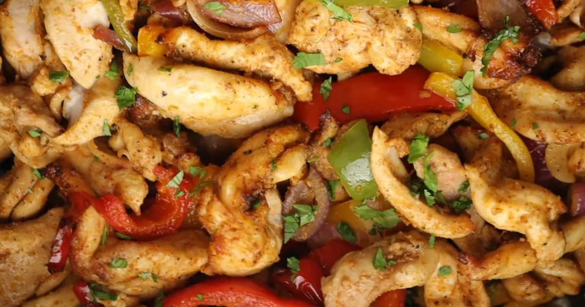 Air Fryer Chicken Fajitas with bell peppers and onions served on a plate
