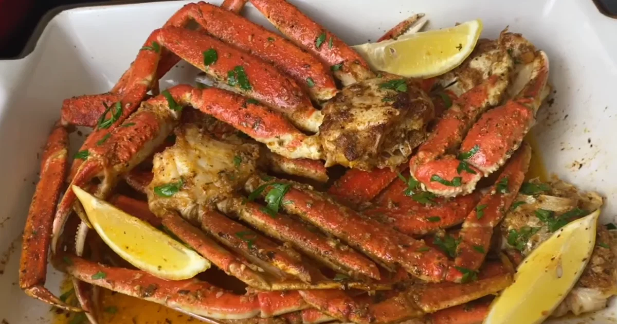 Close-up of Snow Crab Legs served with lemon wedges and dipping sauce