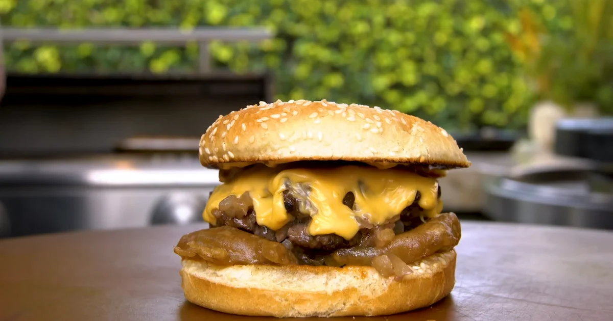 A mouthwatering Western Bacon Cheeseburger with crispy bacon, melted cheese, and smoky barbecue sauce on a toasted bun