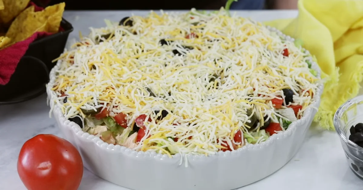 Creamy Taco Dip with Cream Cheese served in a bowl with tortilla chips