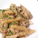 Philly Cheesesteak Pasta served in a bowl with creamy cheese sauce and tender steak slices.