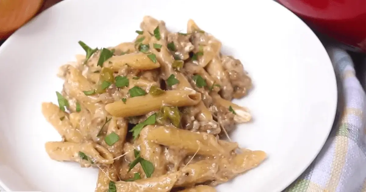 Philly Cheesesteak Pasta served in a bowl with creamy cheese sauce and tender steak slices.