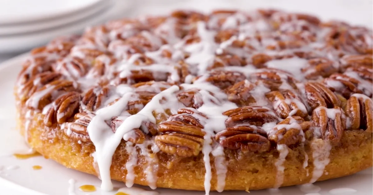 A freshly baked pecan pie cake topped with toasted pecans, perfect for dessert.