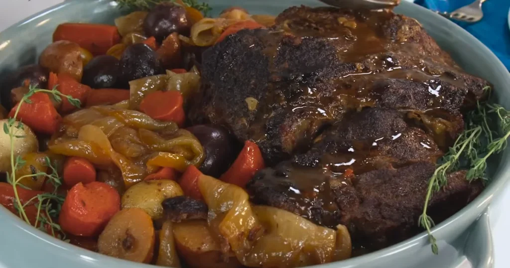 Delicious pot roast with vegetables, served on a plate with rich gravy.