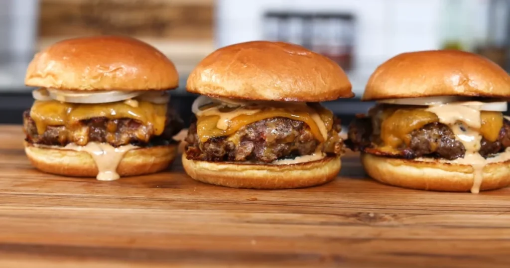 Juicy Crack Burgers with melted cheese, fresh toppings, and a golden brown bun.