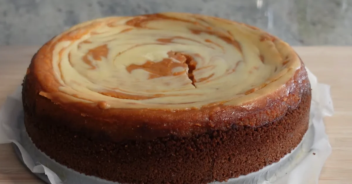 Delicious slice of Sweet Potato Cheesecake topped with whipped cream and cinnamon.
